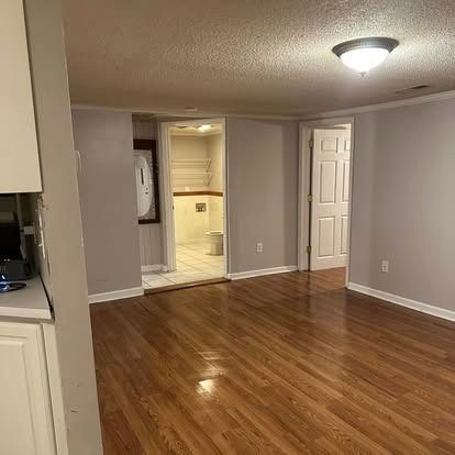 A living room with hardwood floors and gray walls.
