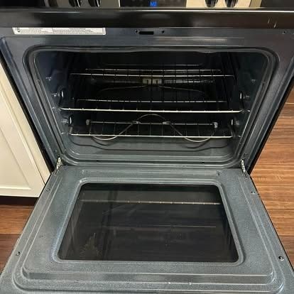 The inside of an oven is shown with the door open.