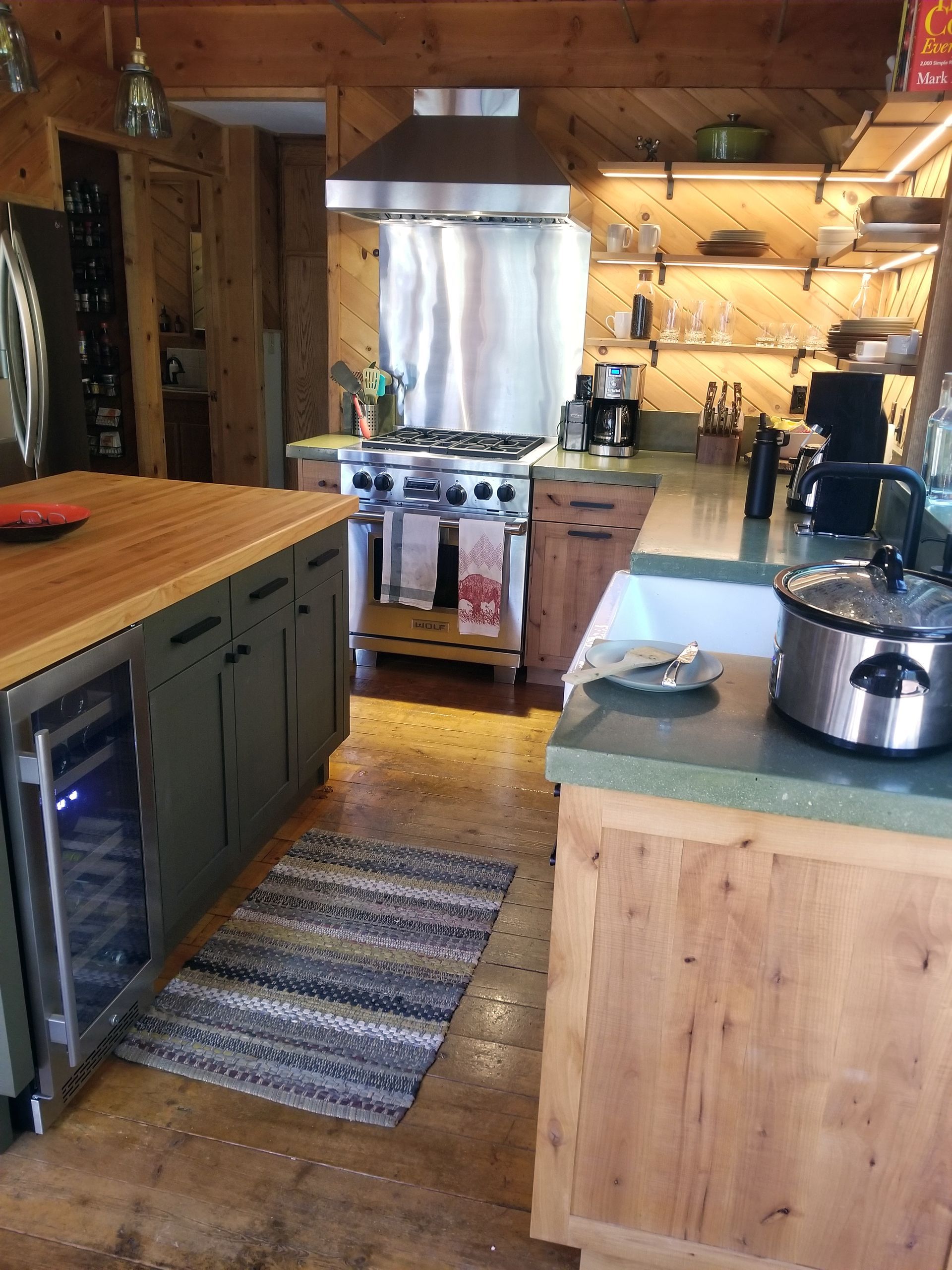 A kitchen with stainless steel appliances and wooden cabinets