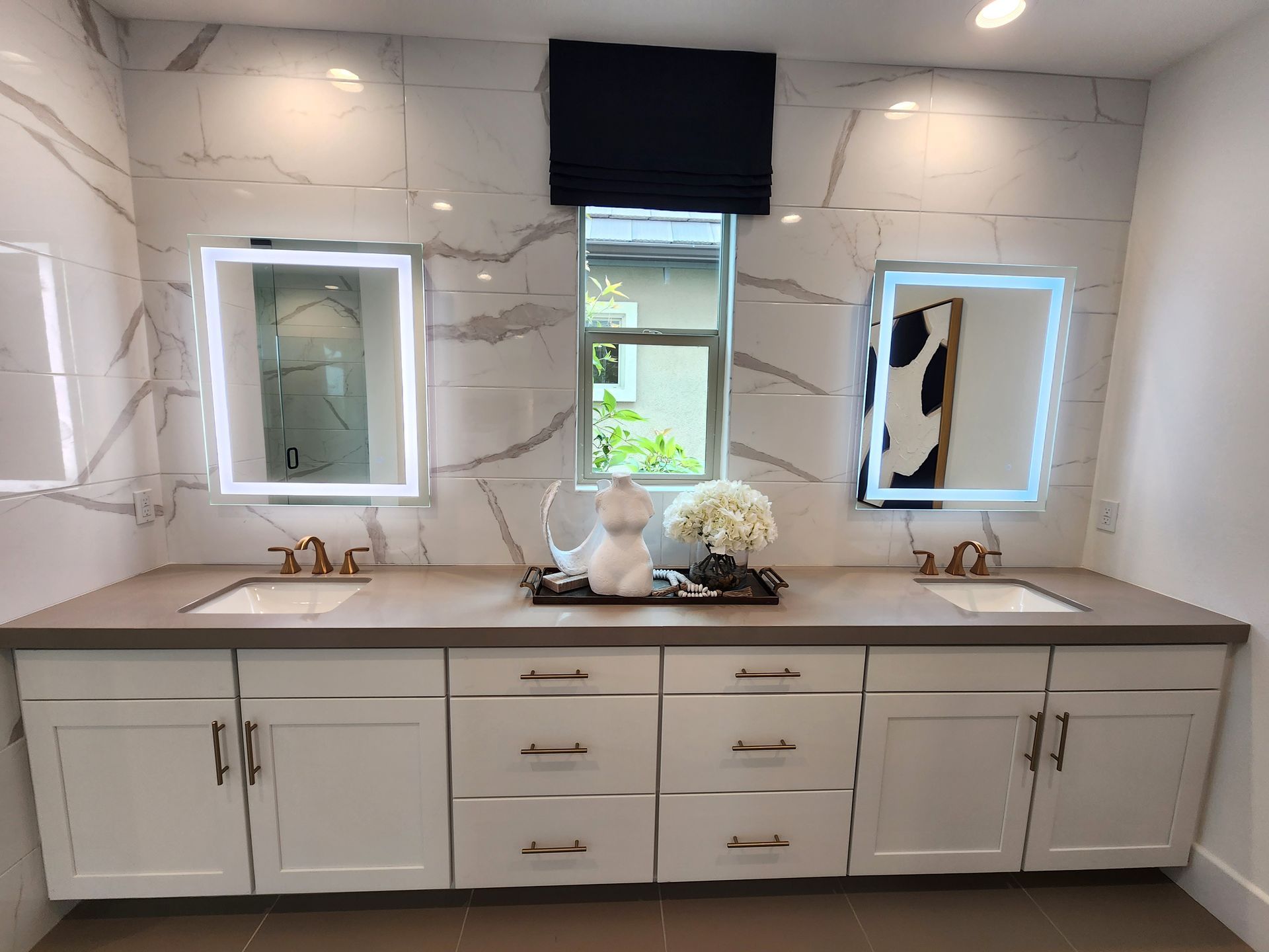 A bathroom with two sinks and two mirrors.