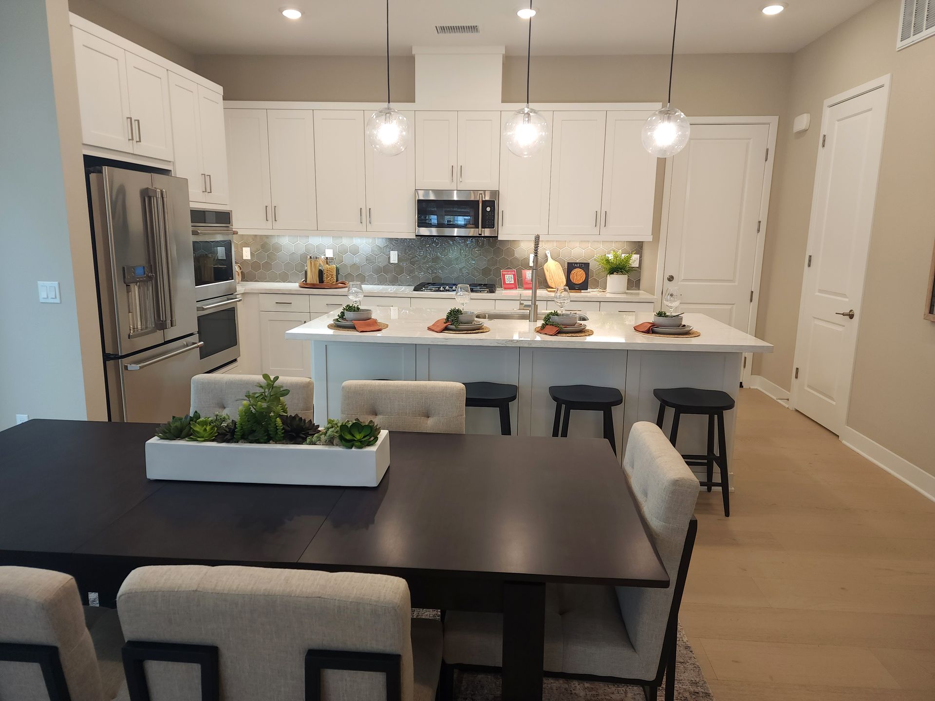 A kitchen with a table and chairs in it