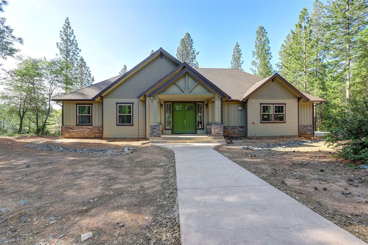 A house with a green door and a walkway leading to it