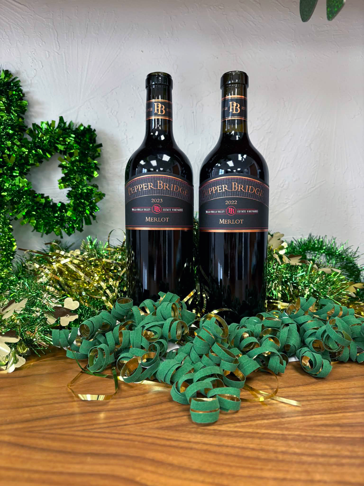 A bottle of 2022 Merlot and a bottle of 2023 Merlot