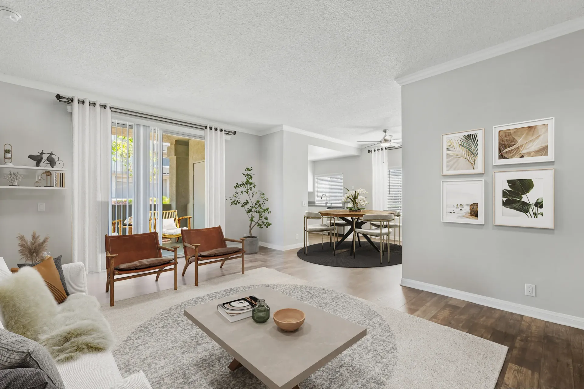 Bright living room with seating and open dining area near sliding glass doors.