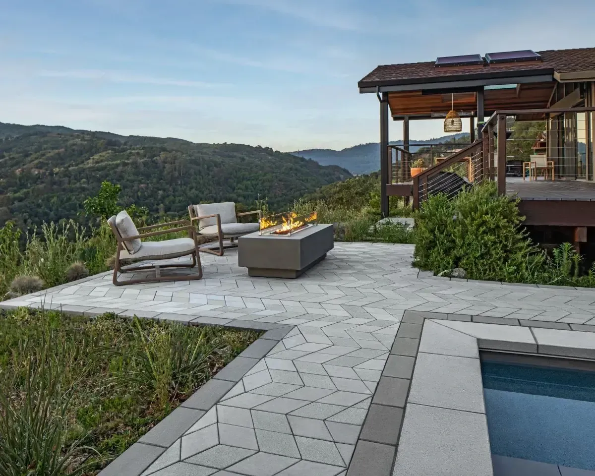 Outdoor white brick BBQ grill with sea view.