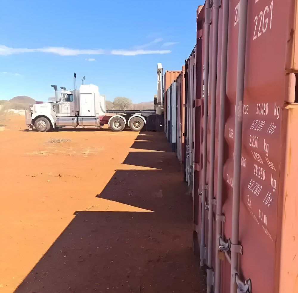 A Truck Is Parked Next To A Row Of Shipping Containers With The Number 2301 On The Side — Go Pack Yourself in Braitling, NT
