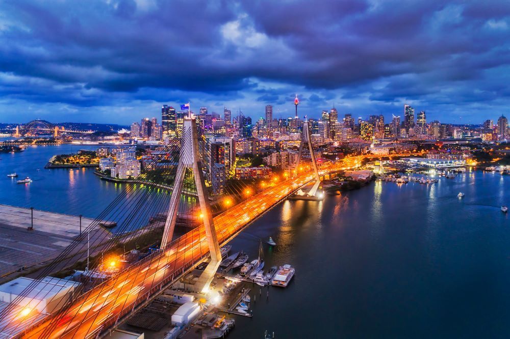 An Aerial View of a City at Night With a Bridge Over a Body of Water — Go Pack Yourself in Sydney, NSW