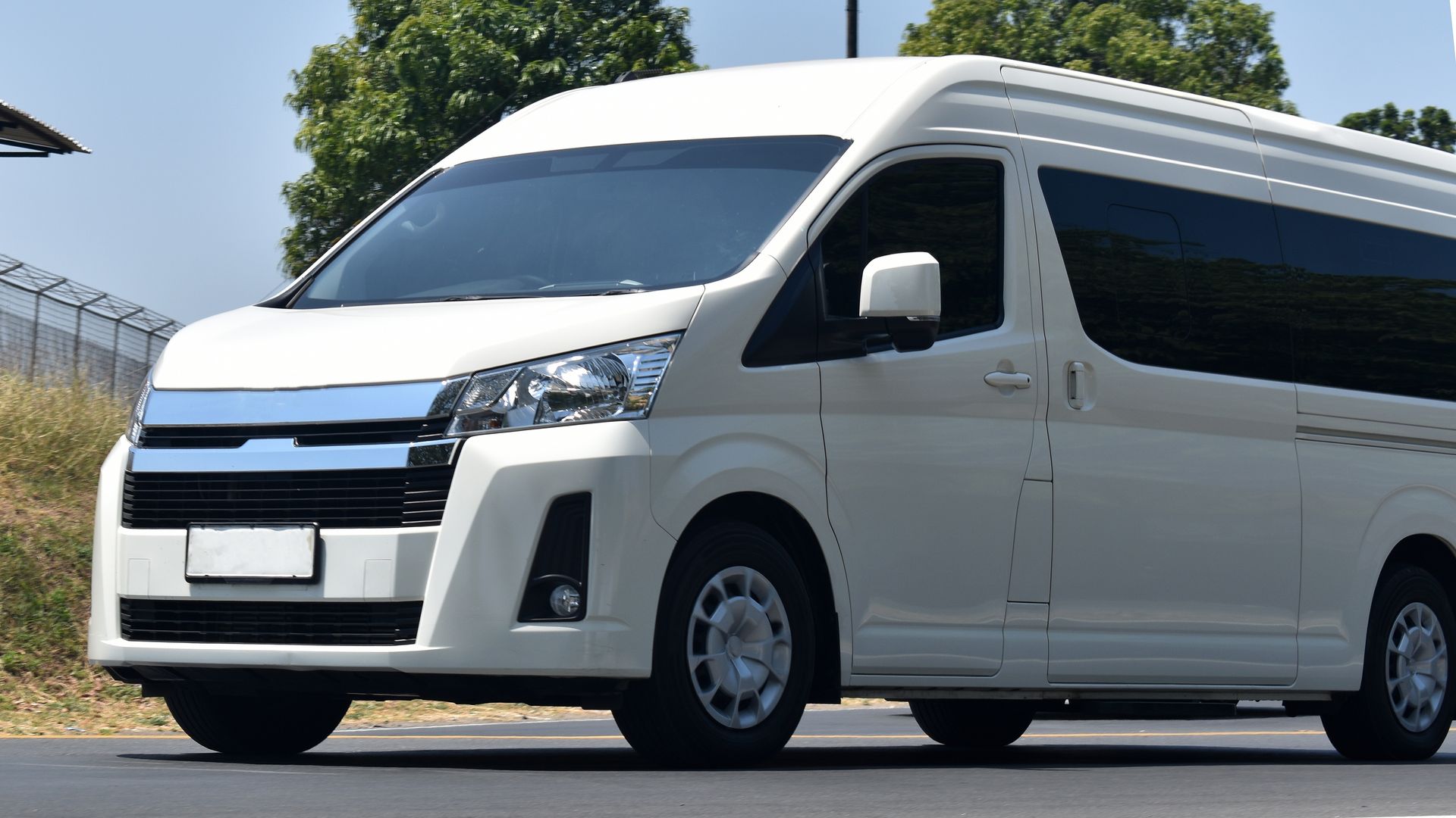 White Passenger Van Driving on a Road — Crown Rental Cars in Nightcliff, NT