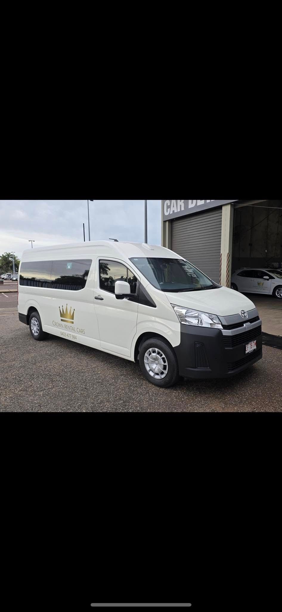 White Toyota Hiace van parked on a gravel surface next to a building. — Crown Rental Cars in Nightcliff, NT