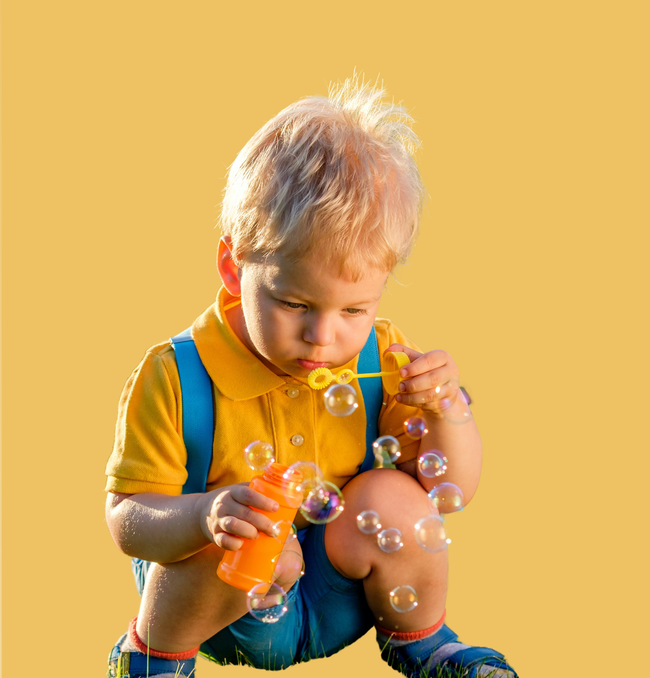 Young boy playing with bubbles