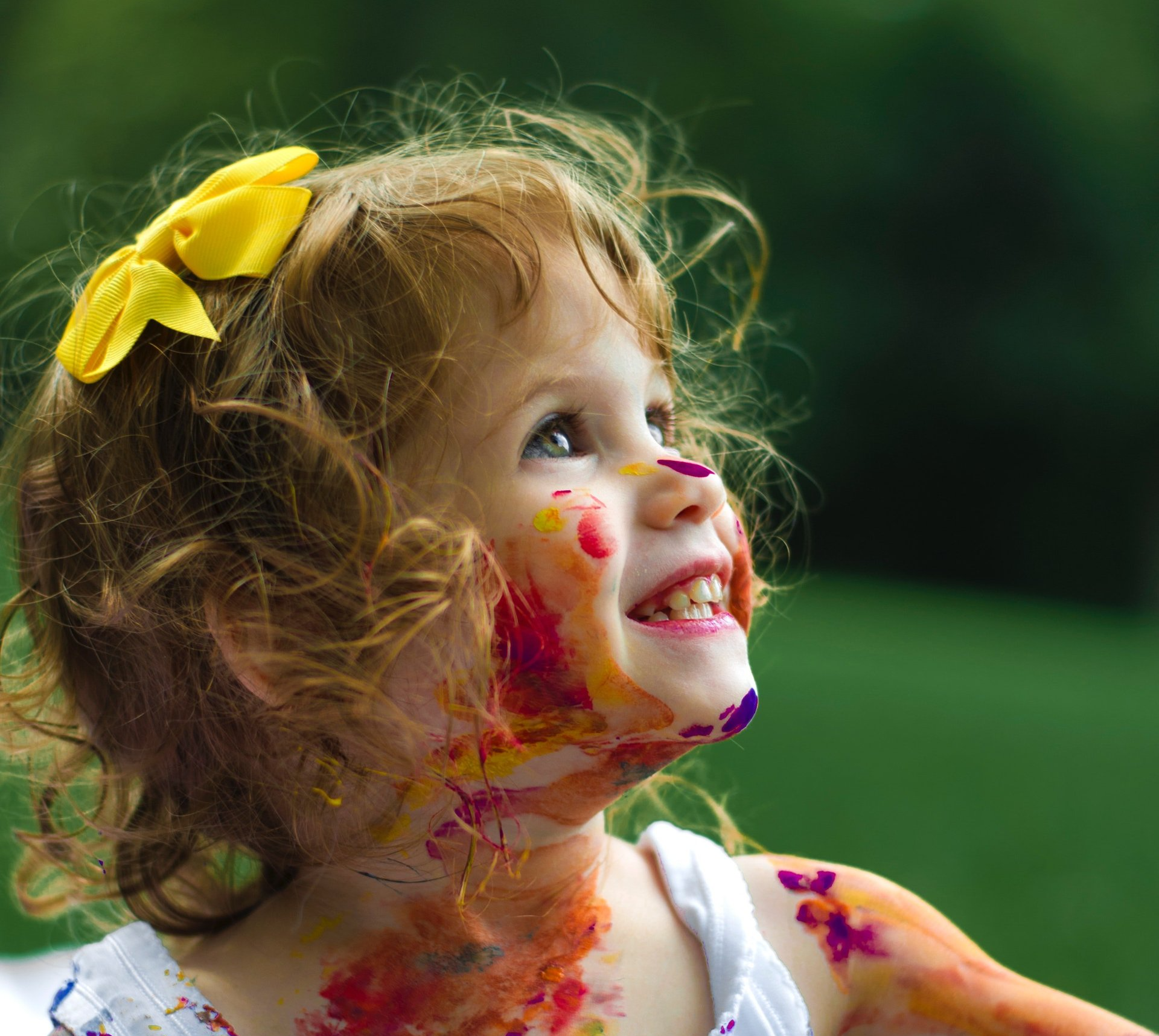 Young toddler with paint on her face