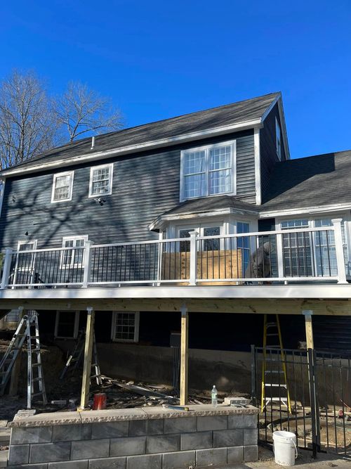 A large house with a large deck underneath it.