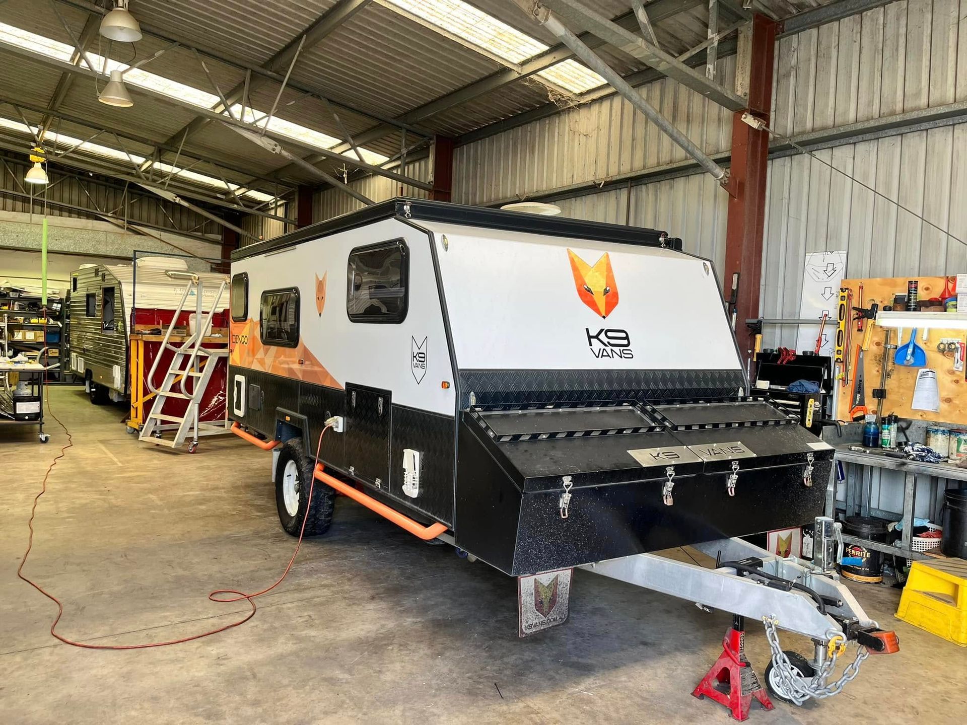 Off-road Camper Trailer, White, Orange, And Black, Inside A Garage — Torque Metro Caravan Services in Archerfield, QLD