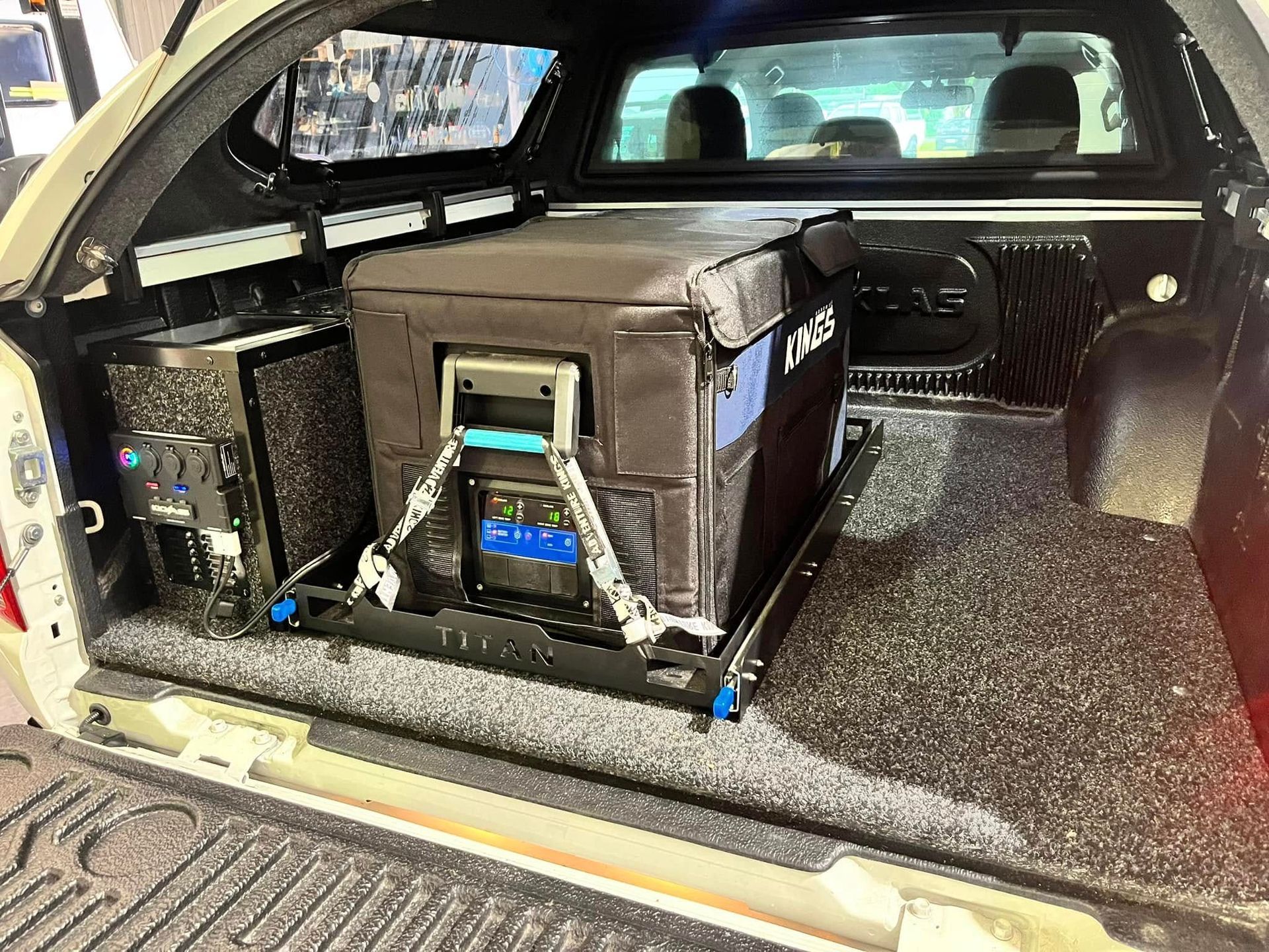A White Pickup Truck Bed With A Fridge And Battery Setup — Torque Metro Caravan Services in Archerfield, QLD