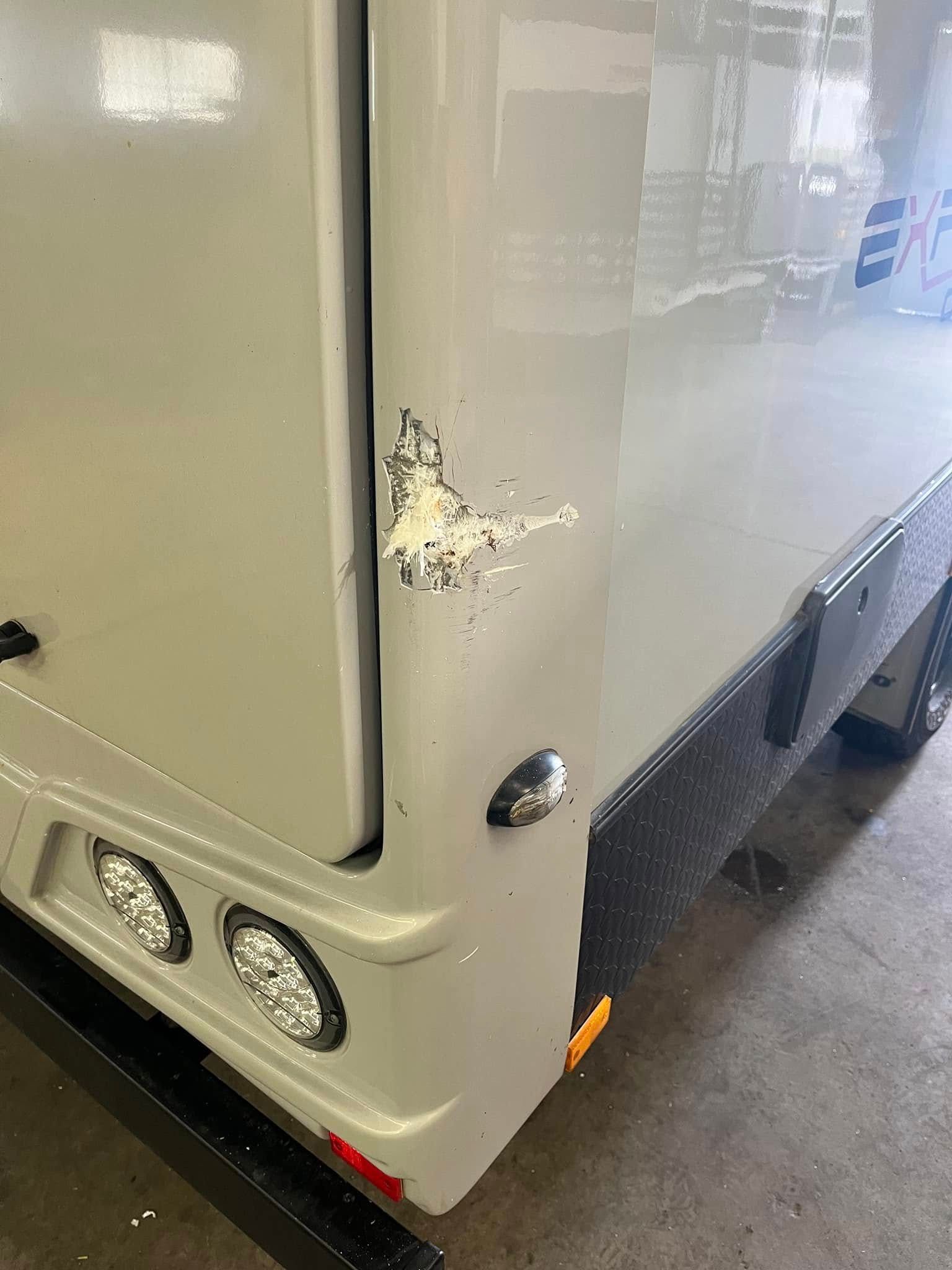 Black Caravan Storage Box With Aluminum Angled Side, Next To The Caravan — Torque Metro Caravan Services in Archerfield, QLD