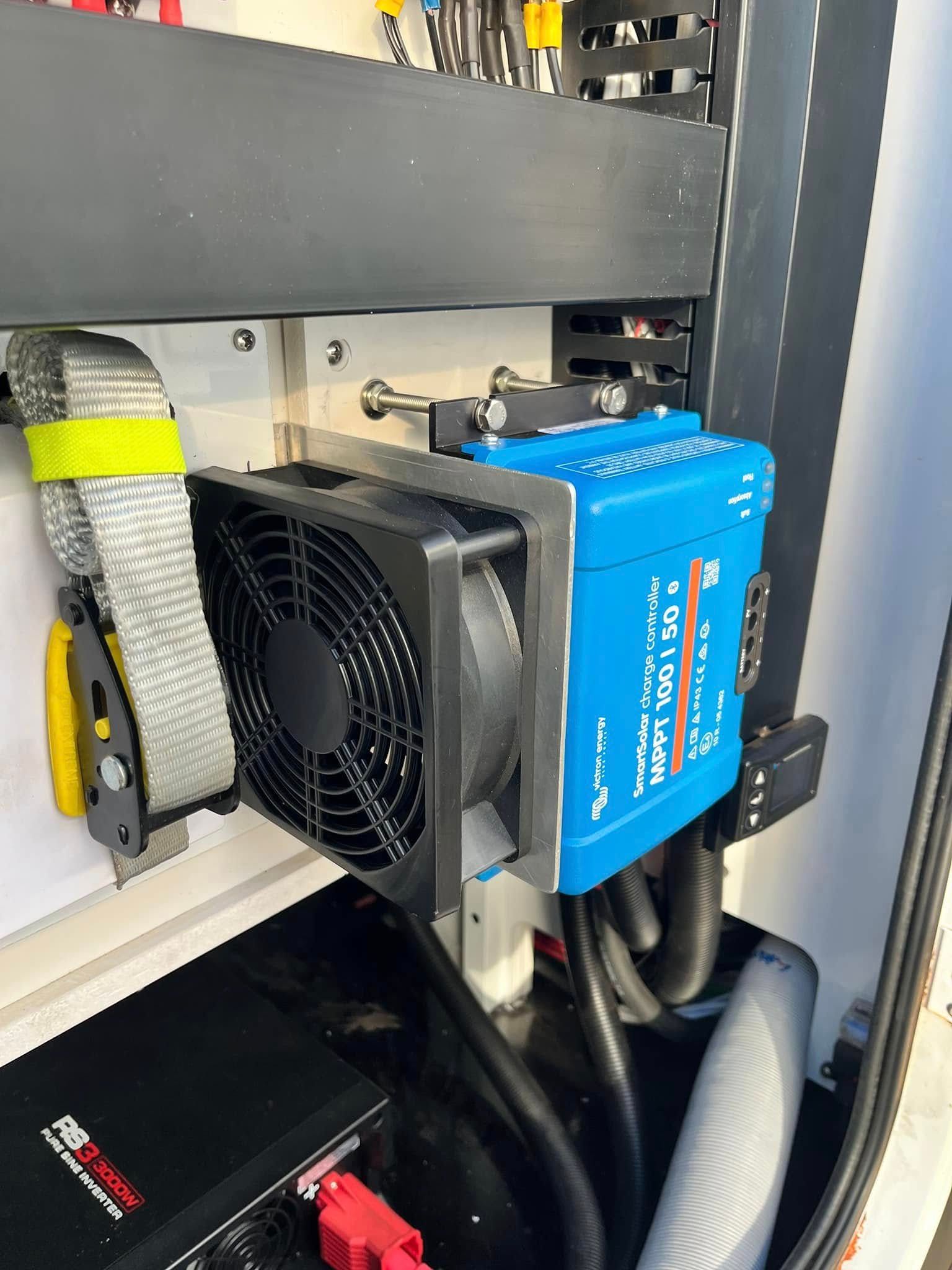 Blue Inverter With Attached Fan In A Vehicle's Storage — Torque Metro Caravan Services in Archerfield, QLD