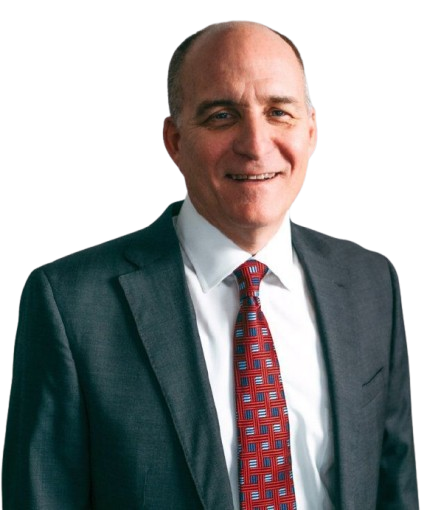 A man in a suit and tie is smiling for the camera