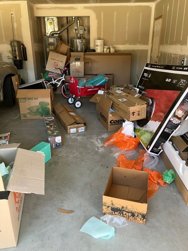 A garage filled with lots of boxes and toys.