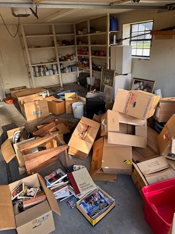 A garage filled with lots of boxes and shelves.