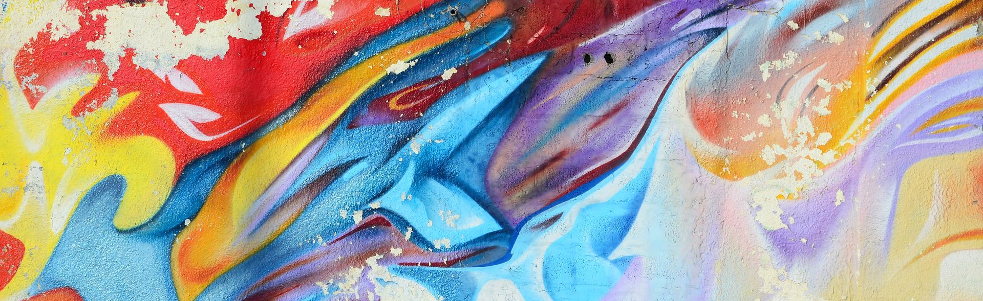 A woman is sitting at a table using a laptop computer.