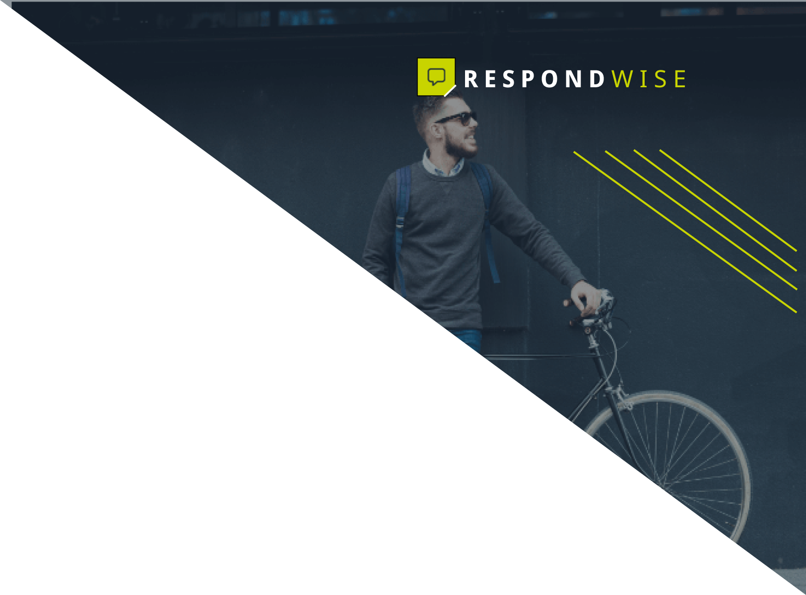 A man is riding a bike in front of a wall.
