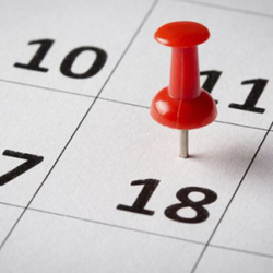 Calendar page with a red pushpin on the date 18.
