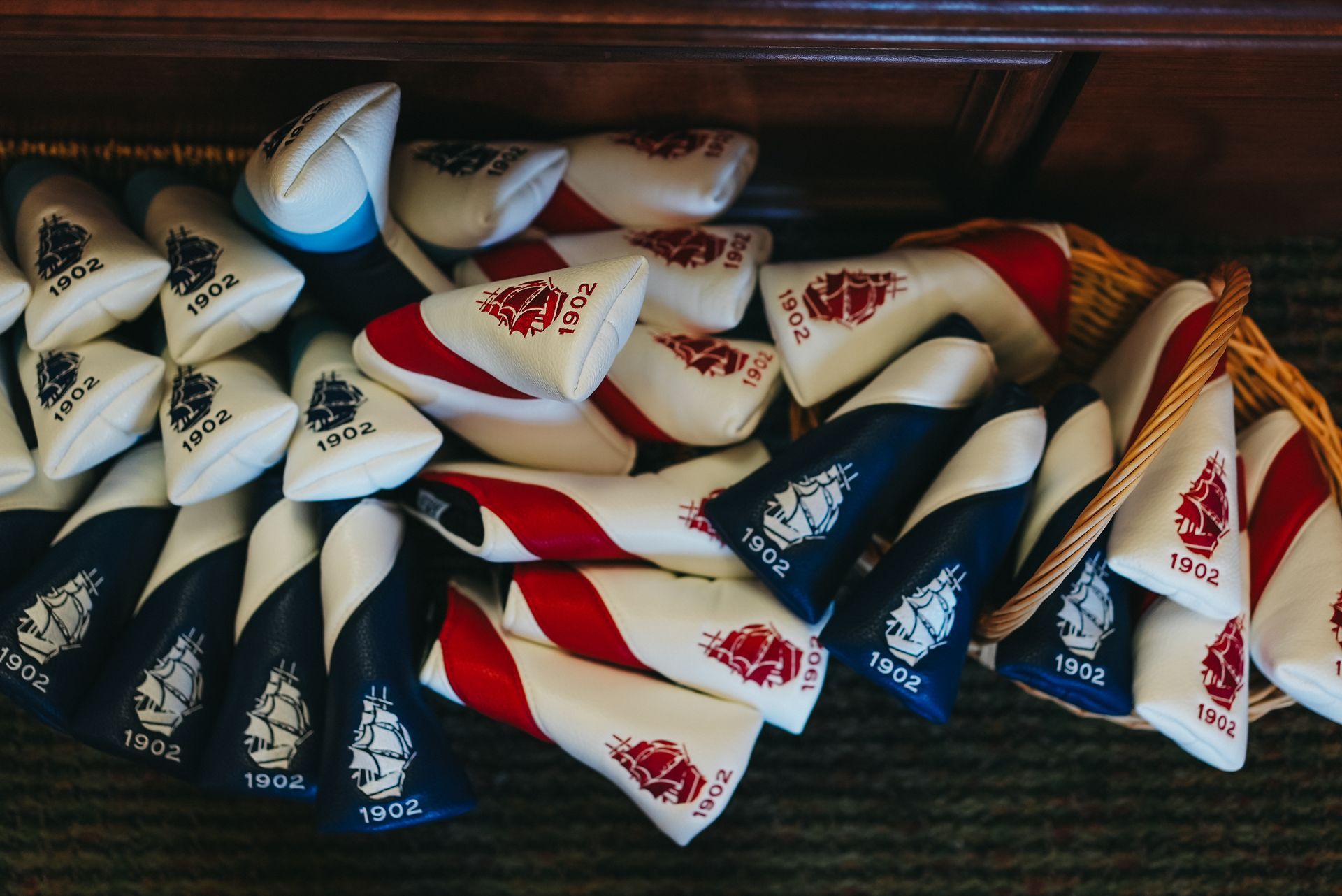 Pile of white, red, and blue triangular objects with a ship logo and 