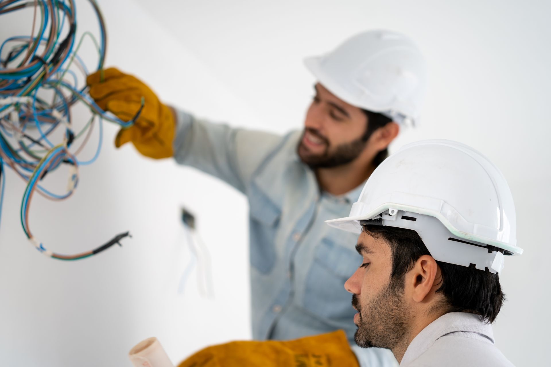 two electricians re-wiring a house