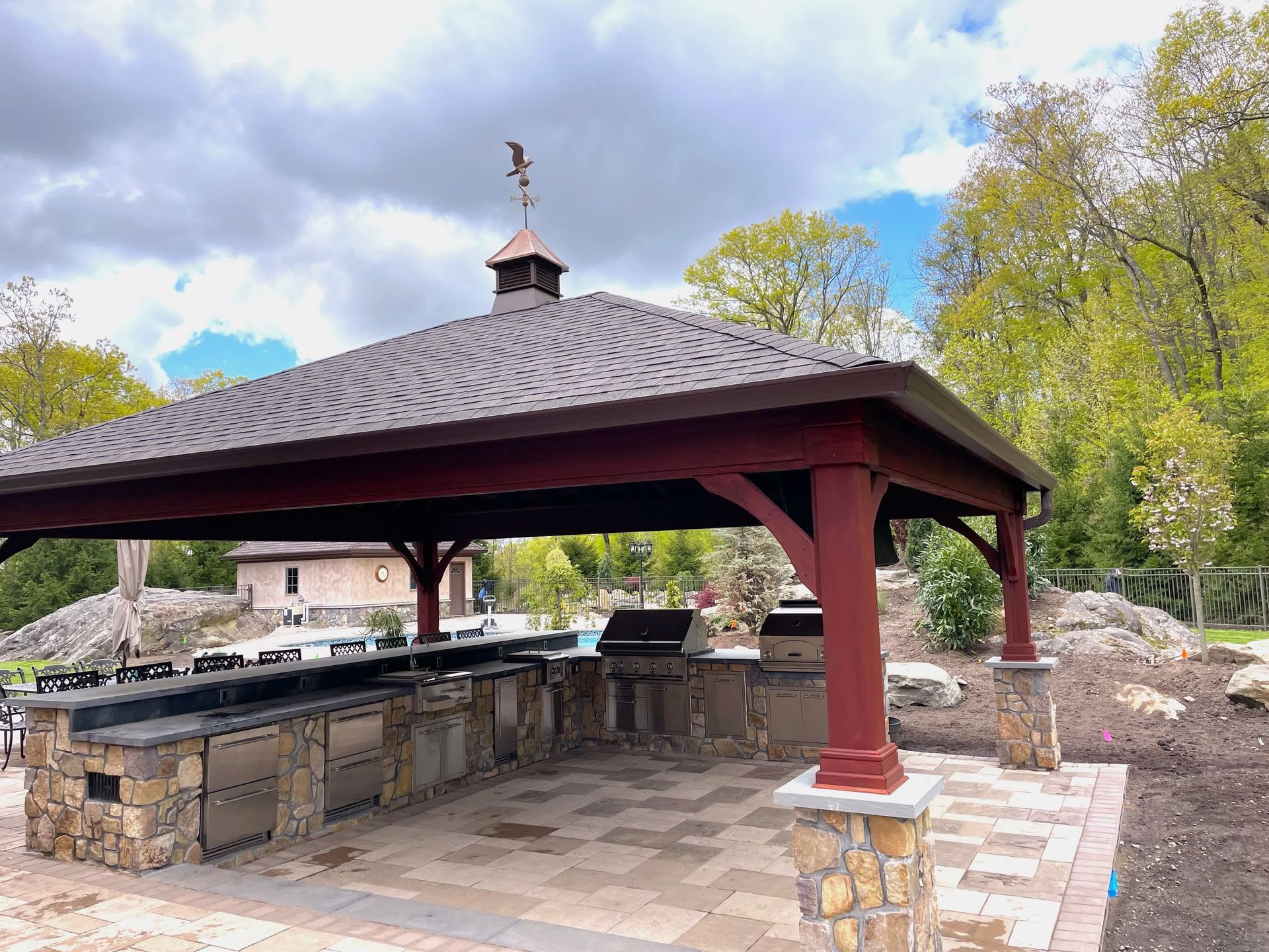 There is a gazebo with a grill underneath it.