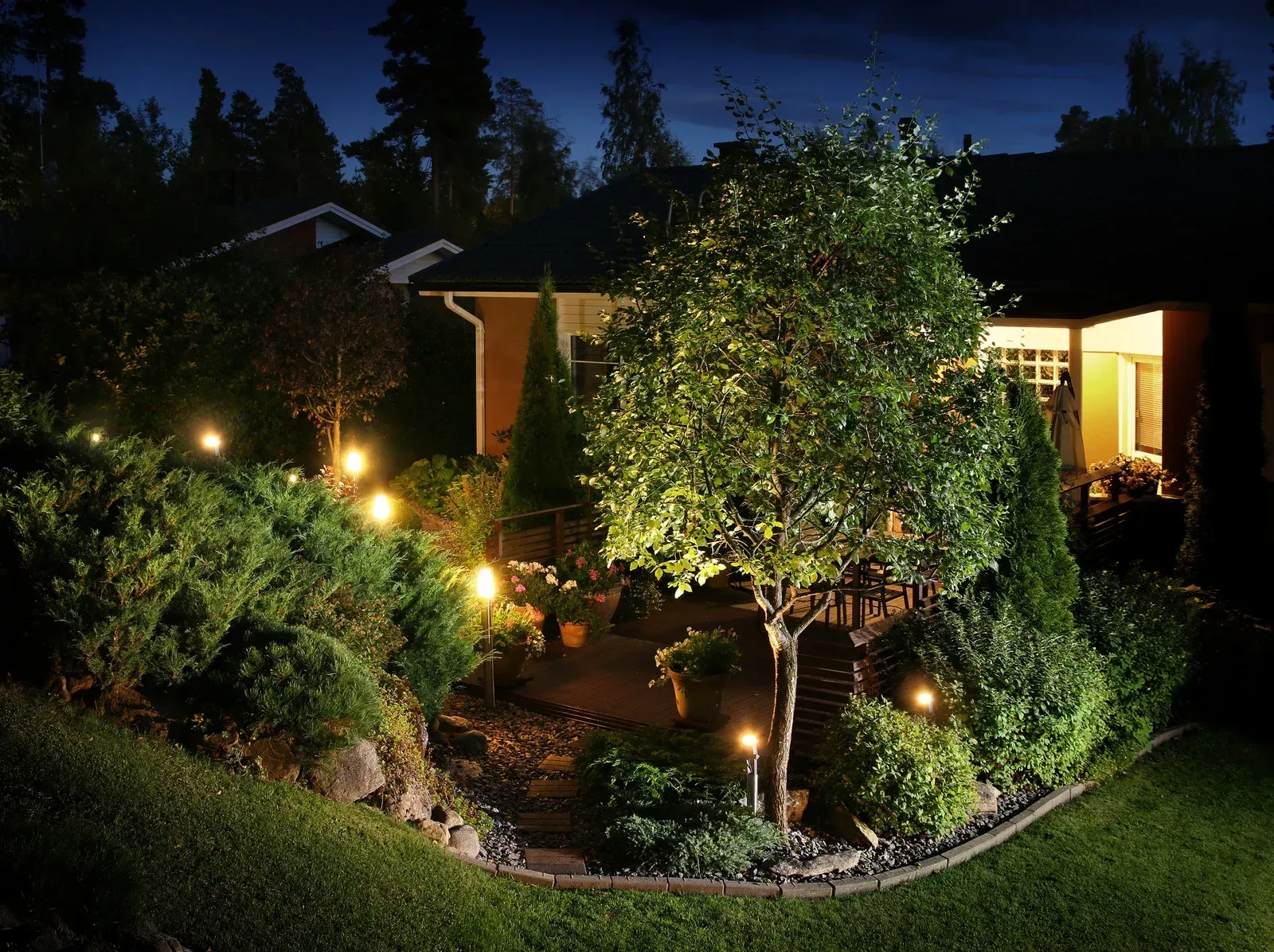 The backyard of a house is lit up at night