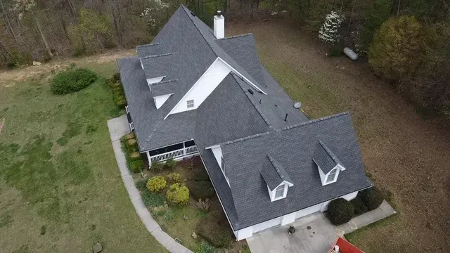 An aerial view of a large house with a gray roof.