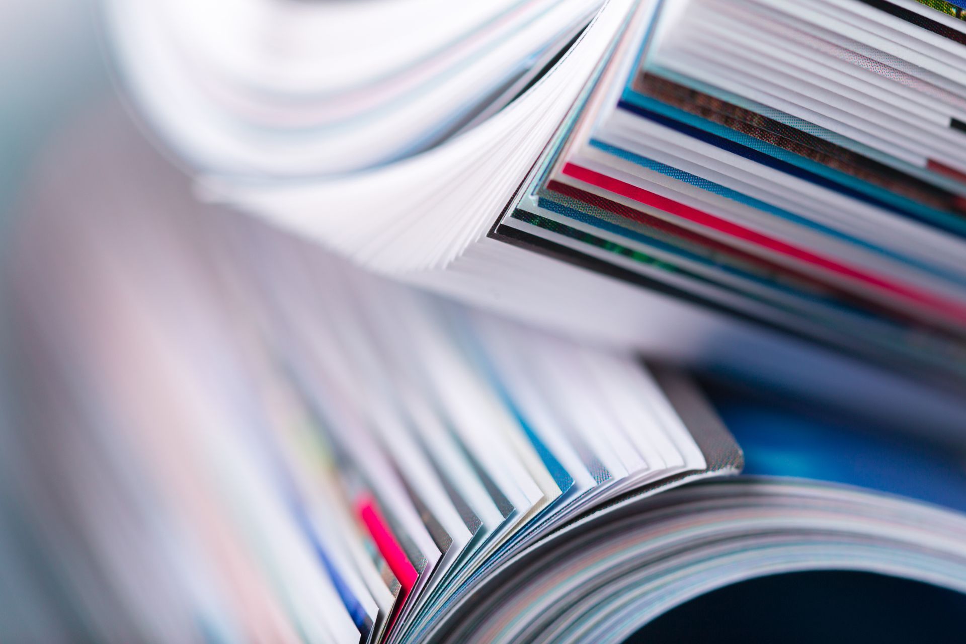 A close up of a stack of magazines on top of each other