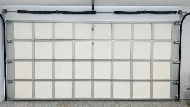 Insulated garage door installed to improve energy efficiency and noise reduction