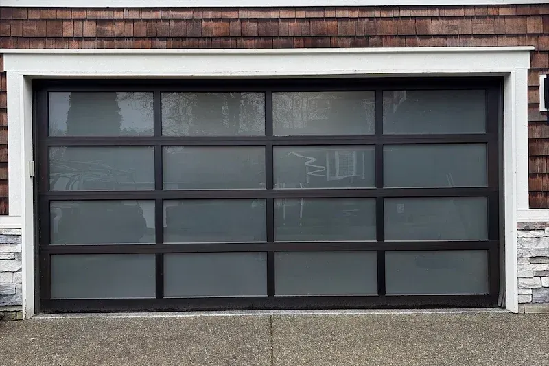 New modern glass panel garage door installed by Eastside Garage Door in Bellevue WA