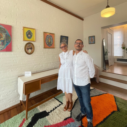 A man and a woman are posing for a picture in a living room