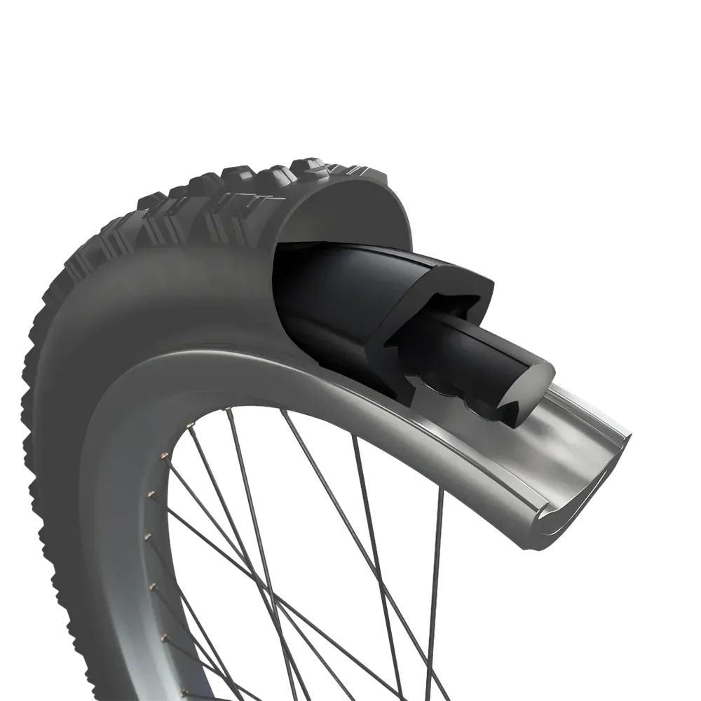 Mountain biker launching off a cliff, another biker below, Red Bull banner, desert setting.