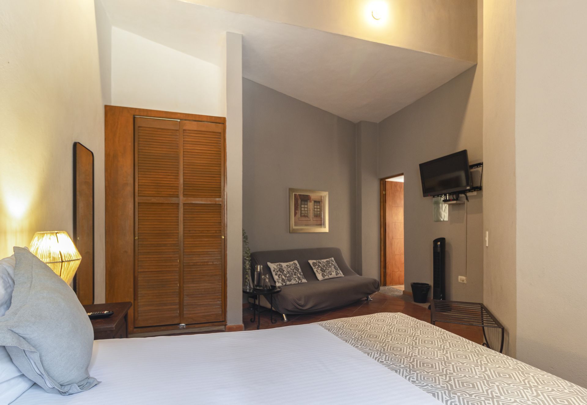 A bedroom with a king size bed and a futon
