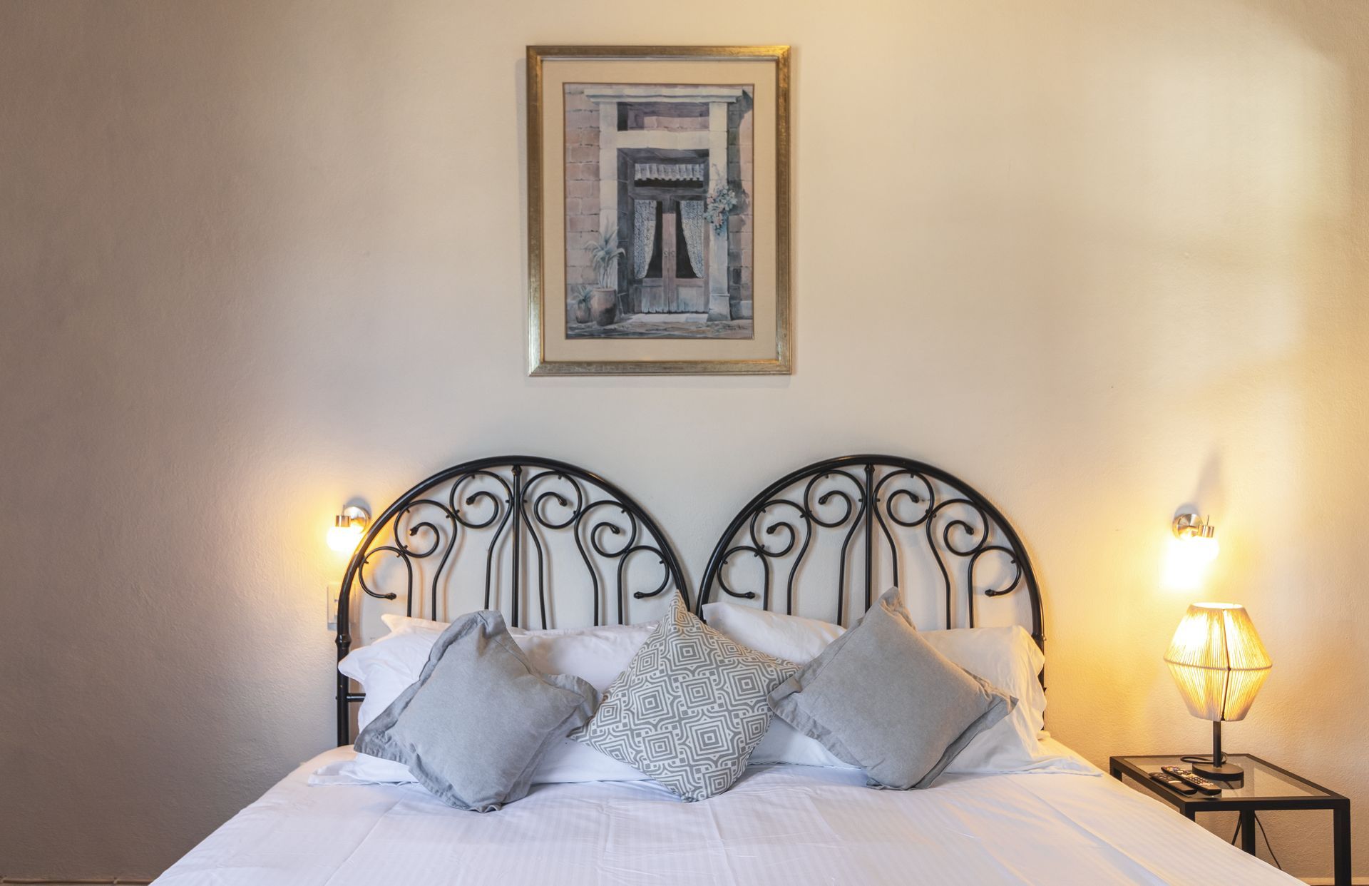 There is a picture on the wall above the bed.