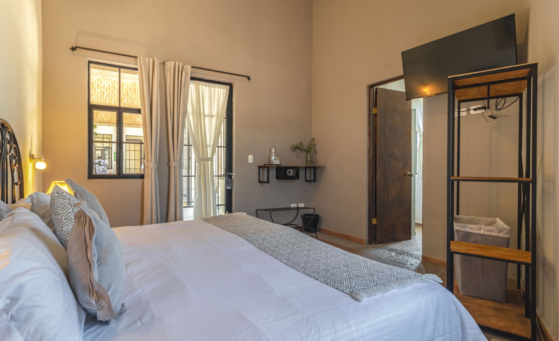 A bedroom with a king size bed and a closet.