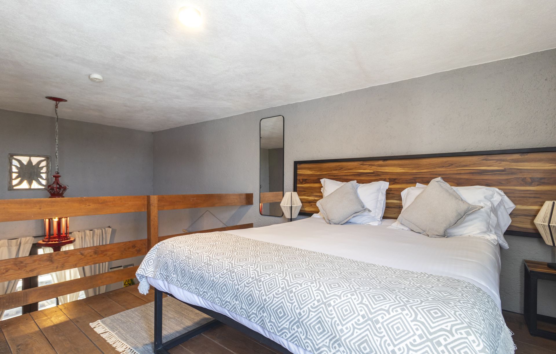 A bedroom with a king size bed and a wooden headboard