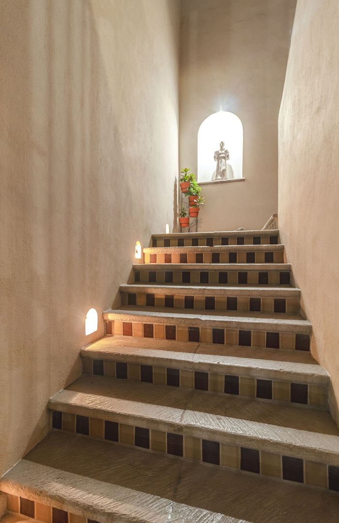 A set of stairs leading up to a window in a building.