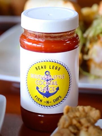 Jar of Beau Legs Southern-style cocktail sauce for fish-n-chips, with a yellow label and anchor symbol.