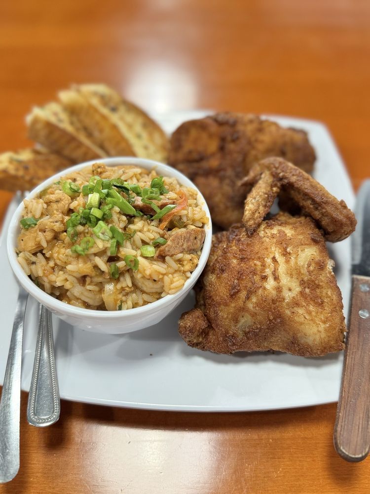Fried chicken, jambalaya, and toast on a plate.