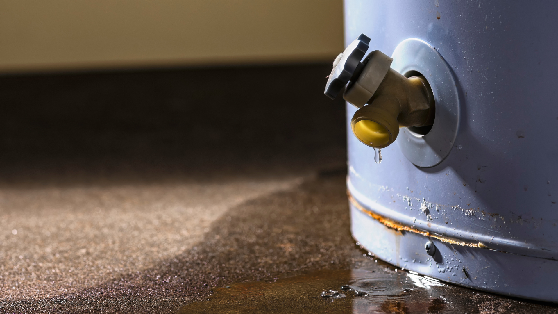 a water heater is leaking water on the floor .