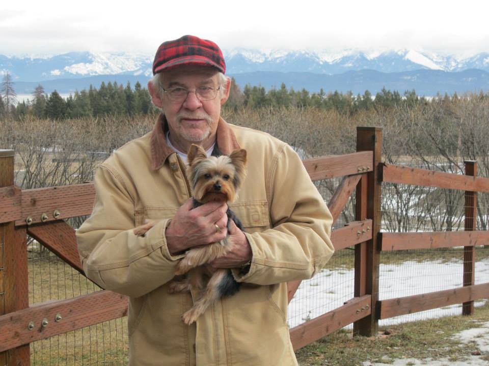 Man Carrying a Yorkshire Terrier Dog — Lakeside, MT — Monica's Pet Grooming & Boarding