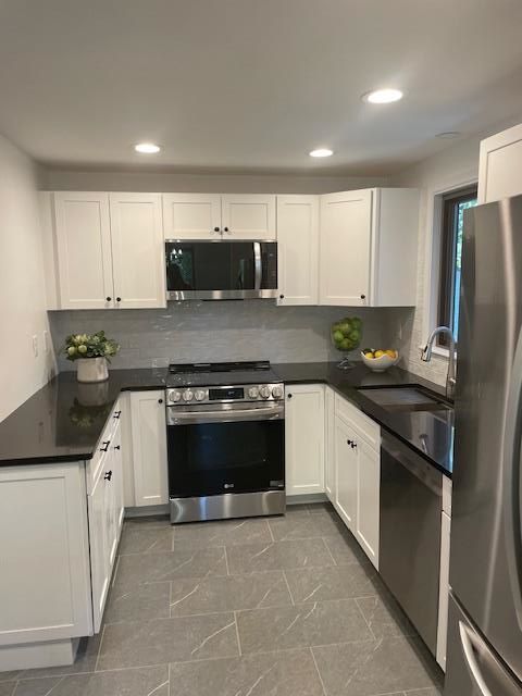 a kitchen under construction with a large island in the middle of the room .