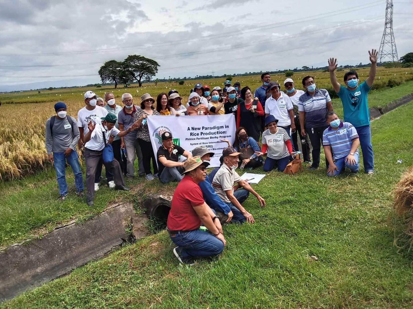 A group of people are posing for a picture in a field.