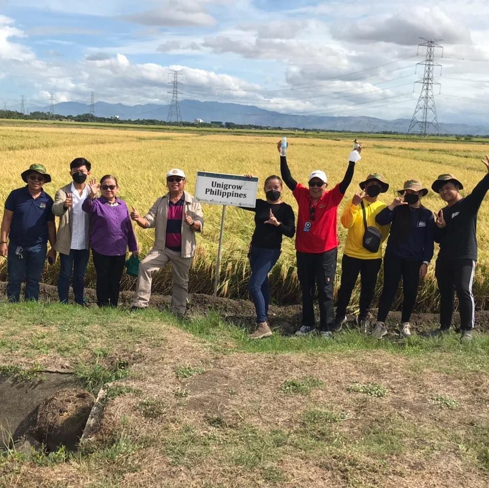 A group of people are posing for a picture in a field