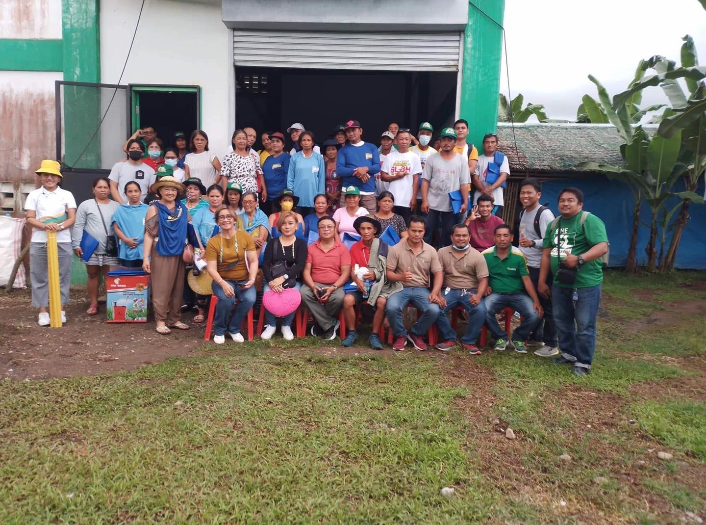 A group of people are posing for a picture in front of a building.