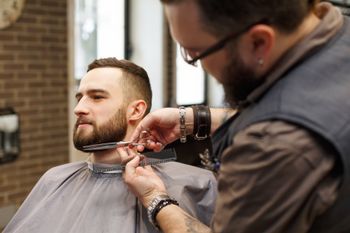 Barber Shaves the Beard of The Client — Troy, MI — The Hair Studio of Troy